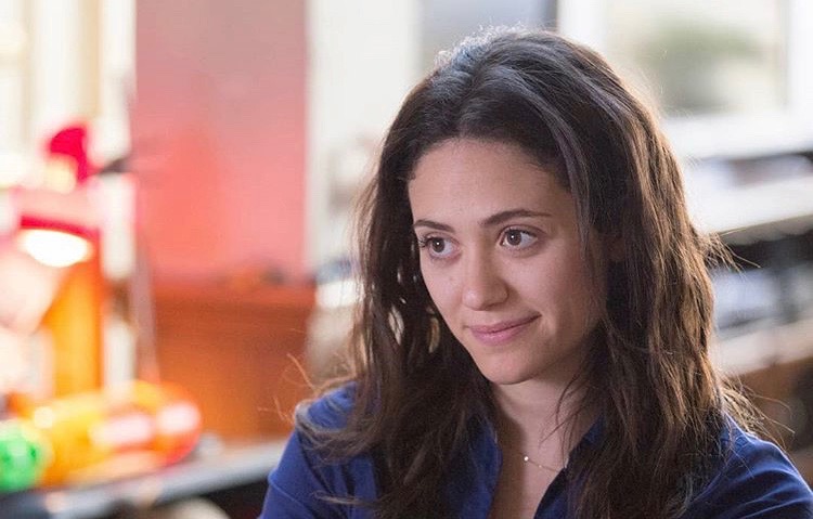 Shameless's Fiona Gallagher (Emmy Rossum) looking off-camera to the left with a soft smile on her lips